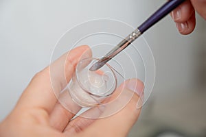 The master mixes eyebrow dye.