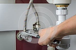 Master plumber repairs water faucets