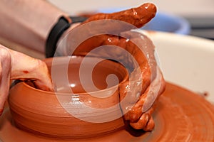 Master potter creates an earthen bowl Close-up