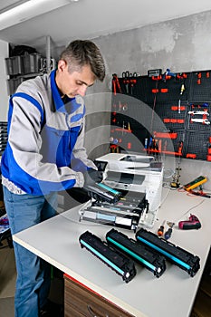 Master professional refills laser printer cartridges in the workshop