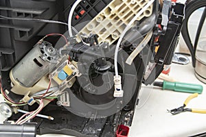 The master repairing broken coffee machine,disassembled coffee machine,Inside the coffee machine. The interior of a