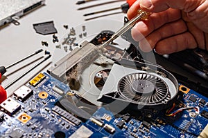 The master repairs the laptop from overheating