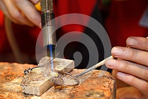 Master soldering jeweller ornament. photo