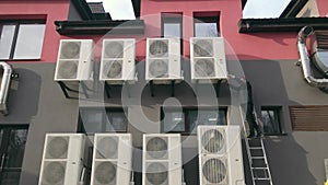 Master who repairs large industrial air conditioners on the facade of the house. Repair of large air conditioners. An