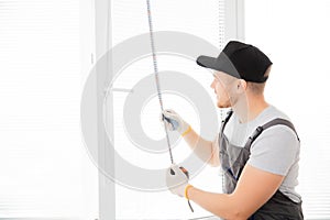 Master worker measures upvc window with ruler, installation process