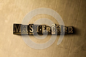 MASTERCARD - close-up of grungy vintage typeset word on metal backdrop photo