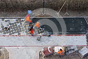 The masters lays paving stones. Sidewalk Repair. Aerial View