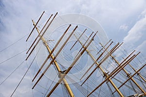 Masts boat rigging of sailing ship against the blue sky