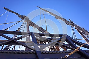 Masts and furled sails on an old wooden sailing ship