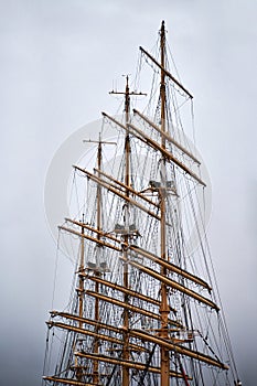 Masts of Kruzenshtern barque ship anchored in city port