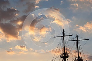 Masts of a pirate ship on sunset