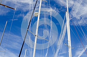 The masts and rigging of several sail boats