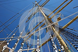 Masts of a sailing ship with the lowered sails.