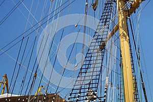 Masts of a sailing ship with the lowered sails.