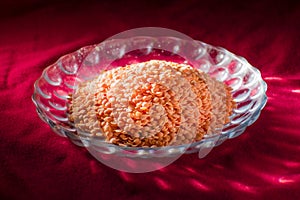 masur dal or Lentil on a decorated glass plater placed on red table cloth