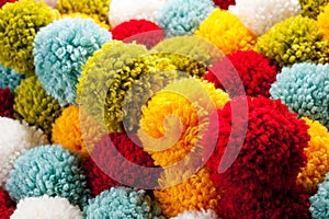 Mat of pompons made from multi-colored handmade yarn