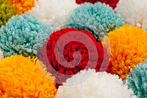 Mat of pompons made from multi-colored handmade yarn