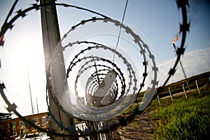 concertina wire fence in industrial area photo
