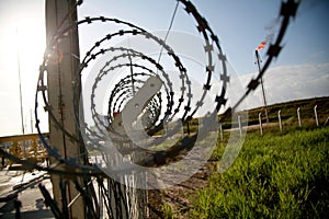 concertina wire fence in industrial area photo