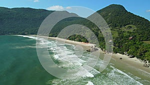 Matadeiro beach with mountains and ocean waves in Santa Catarina, Floripa. Aerial view