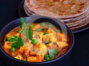 Parartha with matar paneer or peas cottage cheese curry photo