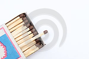 Match box full of matches close up on white background with copy space