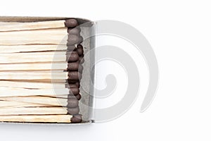 Match box full of matches close up on white background with copy space