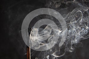 a match burned and extinguished with a thread of smoke
