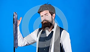 Match colors. Man bearded hipster hold few neckties on blue background. Guy with beard choosing necktie. Perfect necktie