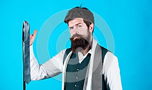 Match colors. Man bearded hipster hold few neckties on blue background. Guy with beard choosing necktie. Perfect necktie