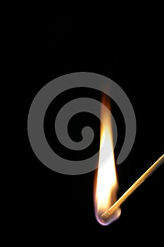 Match flame on black background.