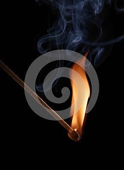 Match flame and smoke on black background