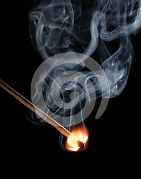 Match flame and smoke on black background