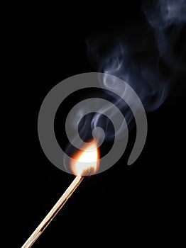 Match flame and smoke on black background