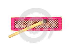 Match on an old and used red or pink box isolated