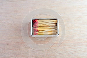 Match stick in box with red head concept energy old vintage on wooden floor background with copy space add text