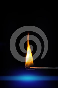 match stick flame in front of a black background