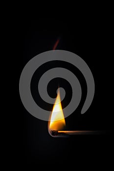 match stick flame in front of a black background