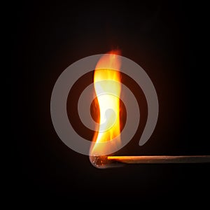 match stick flame in front of a black background