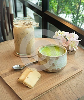 Matcha Green Tea and cookie on wooden tray