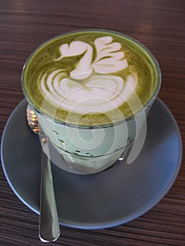 Matcha green tea latte with beauitiful latte art and served in a glass