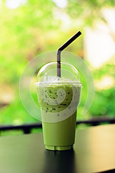Matcha green tea latte clod on wooden table background
