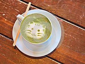 Matcha green tea latte with latte art `Cat face`