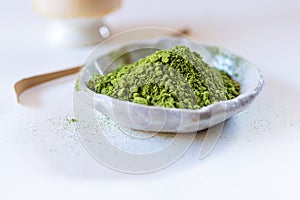Matcha green tea powder in ceramic plate.