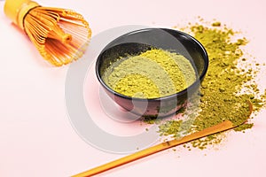 Matcha green tea powder close up on colored background