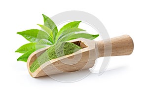 Matcha green tea powder in wood scoop with leaf on white background