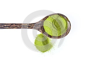 Matcha green tea powder in wood spoon  on white background. top view