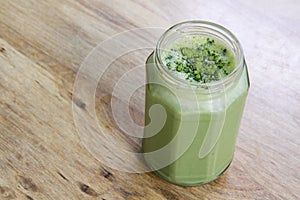 Matcha Green Tea Smoothie in glass jar on table