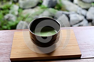 Matcha Japanese green tea served on wooden tray