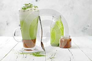 Matcha latte with salted caramel in tall glass
